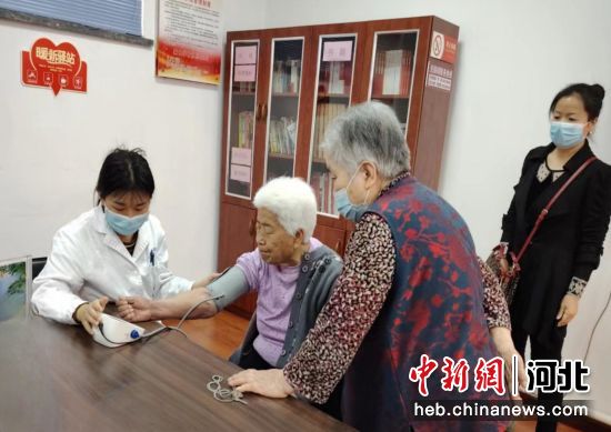 医护人员为居民测量血压。 崔艳敏 摄